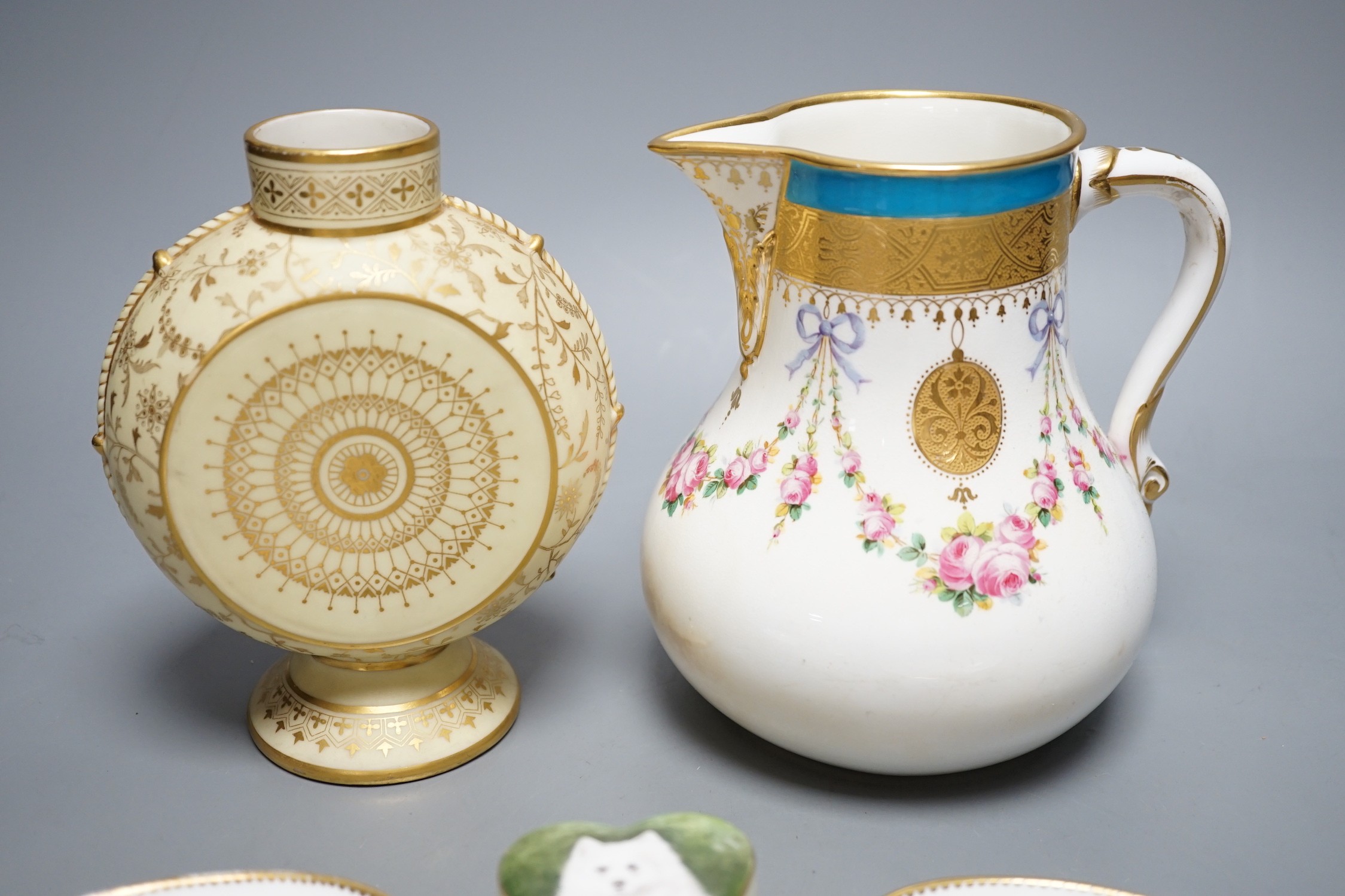 A Minton circular vase with base and neck elaborately gilded on a pale yellow ground, a Minton jug with gilded medallions, rose swags and a turquoise border, two Minton oval dishes painted with dogs by J.E. Dean, signed,